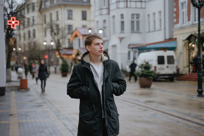 A guy examines the streets of an unknown city, travels alone, during the christmas holidays