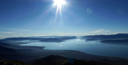 Scenic view of mountains against blue sky