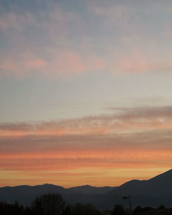 Scenic view of silhouette mountains against sky during sunset