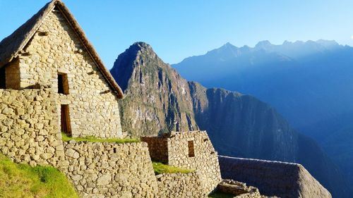 Ruins of building against mountain range