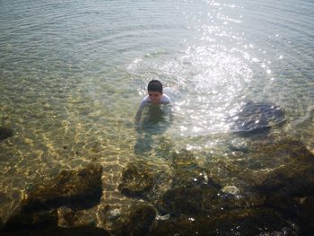 High angle view of man swimming in sea