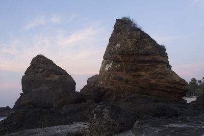 Low angle view of rock formations against sky