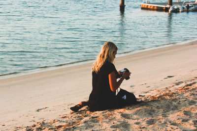 Woman photographing at beach