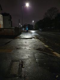 Surface level of street amidst buildings at night