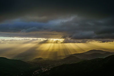 Scenic view of mountains against cloudy sky