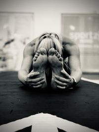 Woman sitting on floor, doing sports exercises