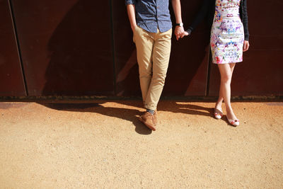 Low section of couple walking outdoors