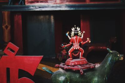 Close-up of buddha statue on table at temple