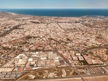 High angle view of townscape by sea against sky