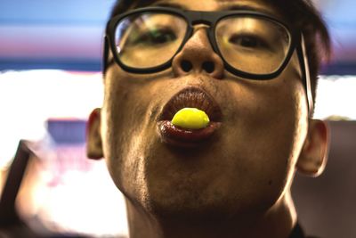 Close-up portrait of young man eating food