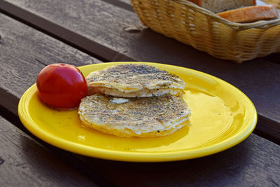 Close-up of pickled hermelin cheese served on wooden table