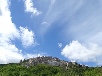 Low angle view of building against cloudy sky