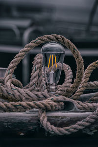 Close-up of rope tied on metal chain