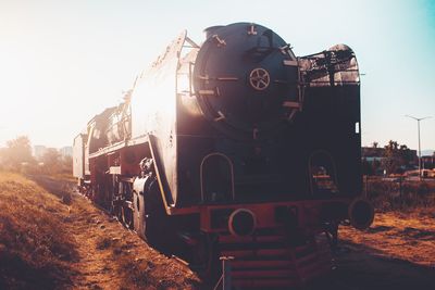 Train on railroad tracks against clear sky