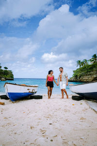 People on beach against sky