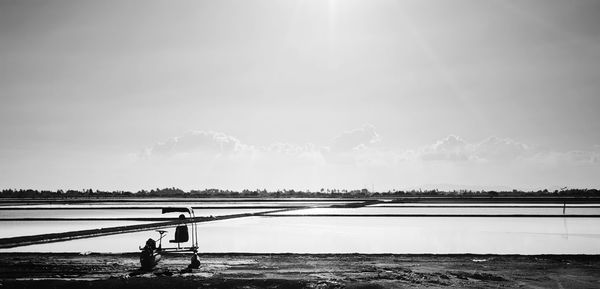 Man in water against sky
