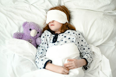 Portrait of woman sleeping on bed at home