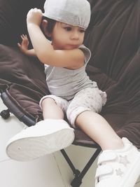 Cute baby girl sitting on sofa