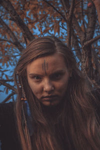 Portrait of angry woman against trees