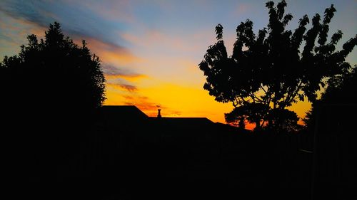 Low angle view of built structure at sunset