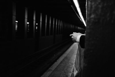 Cropped hand of person waiting on subway station platform