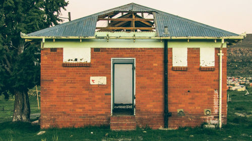 Exterior of house on field against sky
