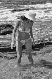 Rear view of woman standing on beach