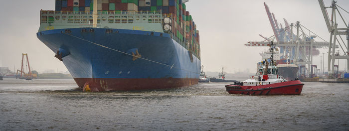 Container ship parking in the port of hamburg during rainy weather