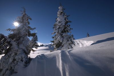 Scenic view of snow covered landscape against clear sky