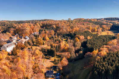 High angle view of autumn trees against sky