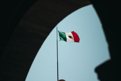 Low angle view of flag against clear sky