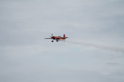 Low angle view of airplane flying in sky