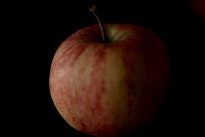 Close-up of apple against black background