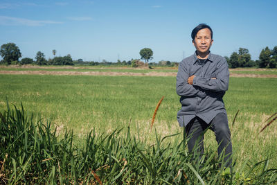 Portrait of man standing in field