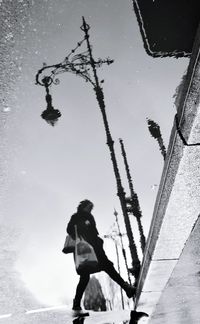 Reflection of man in puddle