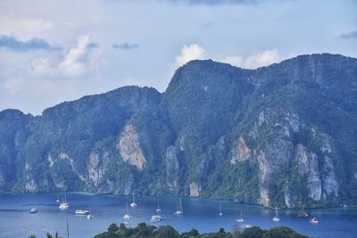 Low angle view of mountain by sea against sky