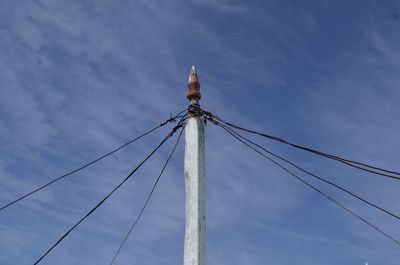 Low angle view of cables against blue sky during sunny day