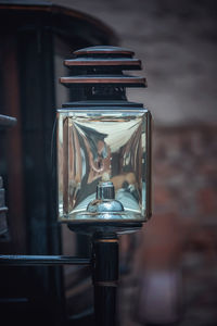 Close-up of electric lamp against wall