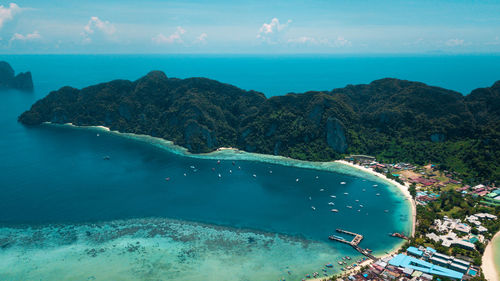 Scenic view of sea and mountains against sky