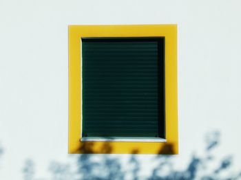 Close-up of yellow window against clear sky