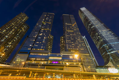 Low angle view of modern skyscraper at night