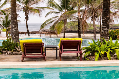 Two deckchairs along the pool facing the indian ocean on watamu beach in kenya
