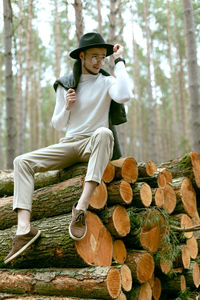 Full length of woman wearing hat in forest