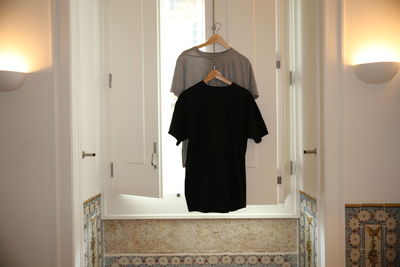 Rear view of man standing in bathroom