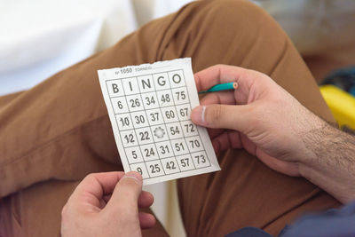 Midsection of man holding text