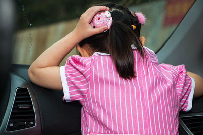 Rear view of woman with pink umbrella