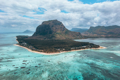 Scenic view of sea and mountains against sky