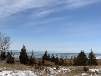 Scenic view of snow covered land against sky