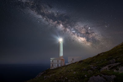 Scenic view of illuminated building against sky at night