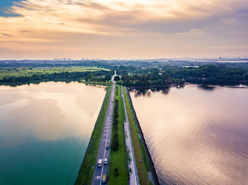 Scenic view of river against cloudy sky